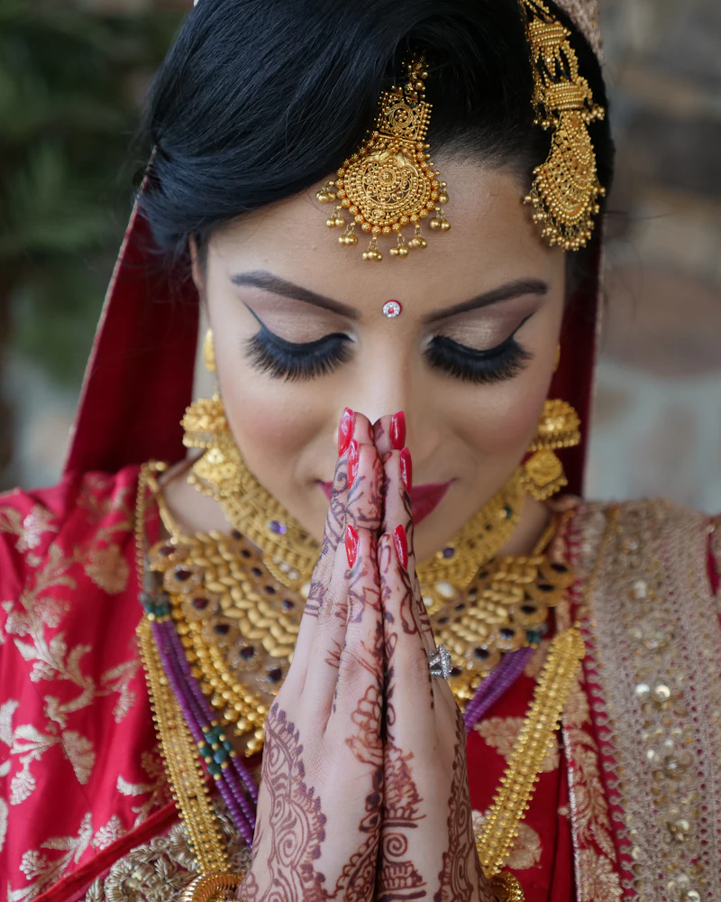 Bride getting ready at the mirror in Finenticee studio, Madhusudan Nagar