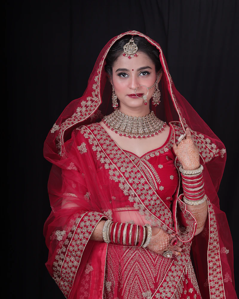 Airbrush bridal makeup on a bride in a red lehenga, Finenticee client