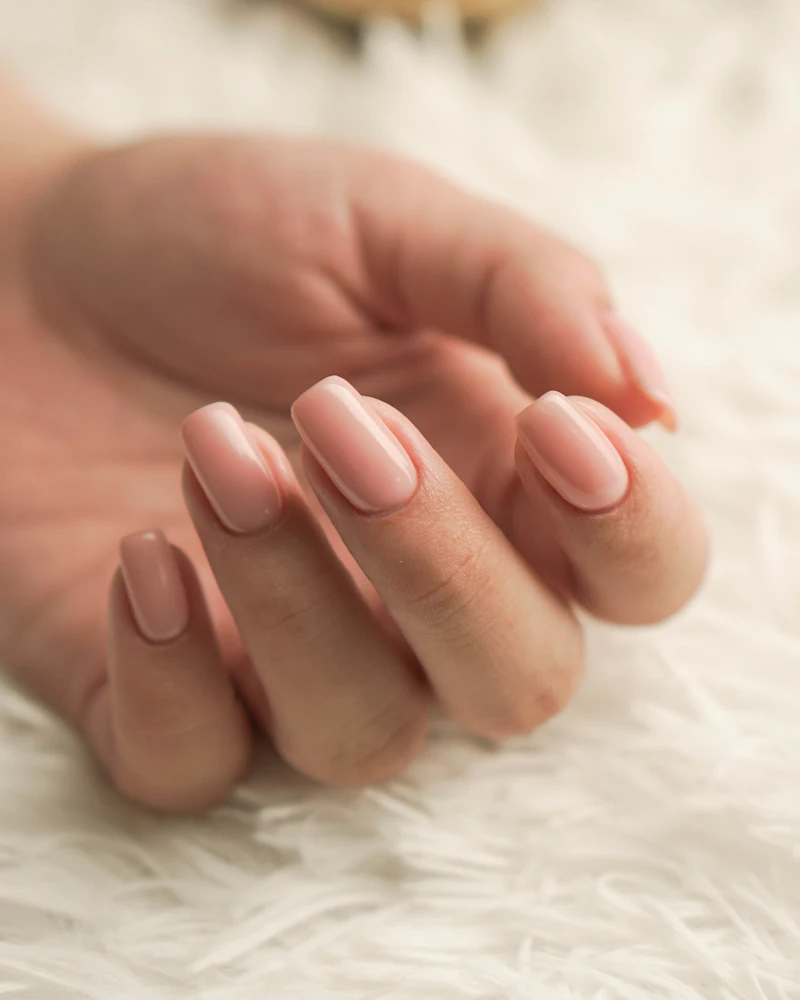 Soft nude gel polish on short natural nails, student work at Finenticee Academy, Bhubaneswar