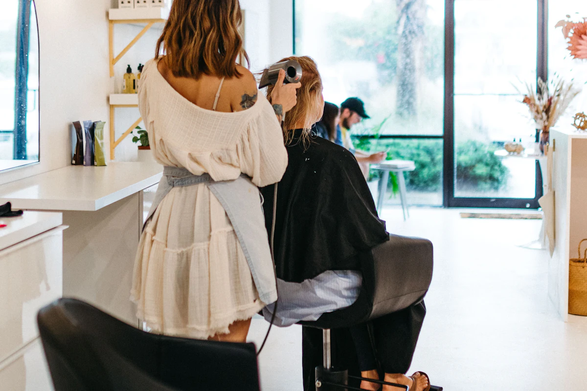 Students practising braids on each other in a Hair Styling Basics class, Finenticee Academy, Bhubaneswar